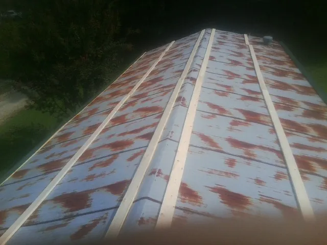Rusted metal roof panels with new wood purlins before replacement — Storm Damage Roof Repair in Fayette by Roofing Brothers